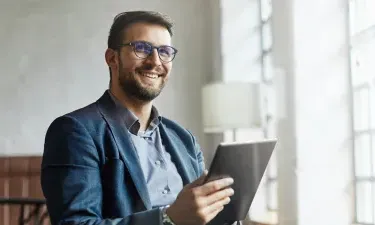 Business analyst from Georgia who graduated with MBA smiling in business meeting